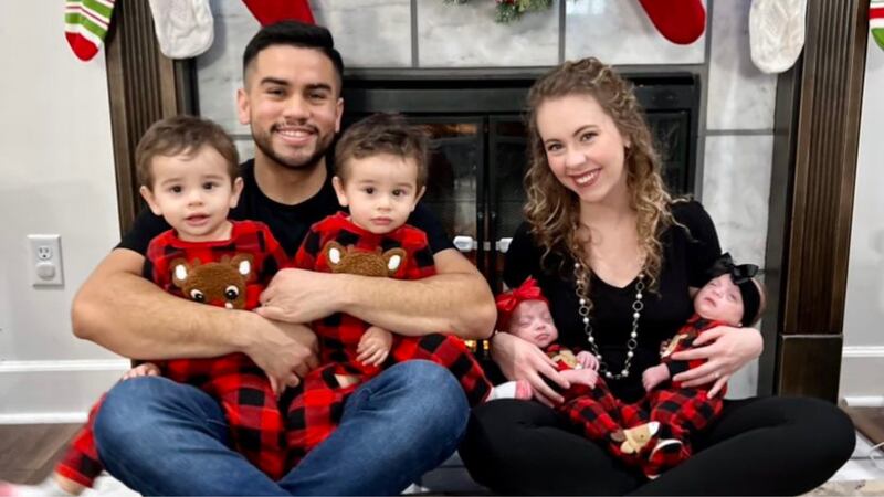 Frankie Alba holds identical twin boys Levi and Luka while Britney Alba holds identical twin...