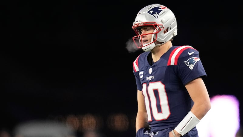 New England Patriots quarterback Drake Maye walks on the sideline during the first half of an...