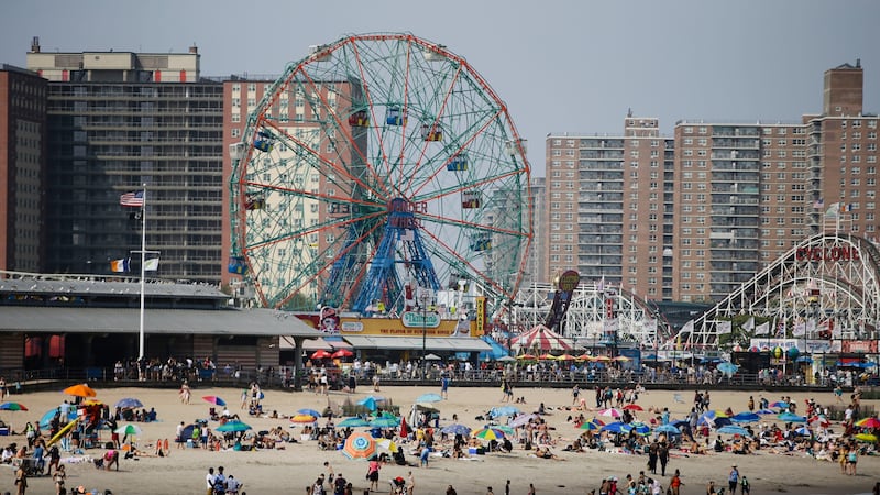FILE PHOTO: People gather at Coney Island beach Friday, July 19, 2019, in New York.